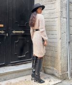 model styling plain knit crew neck dress with belt and boots