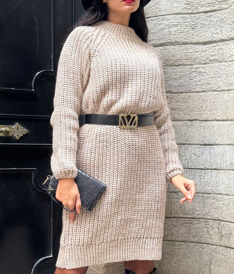 close-up of beige knit dress texture with black belt