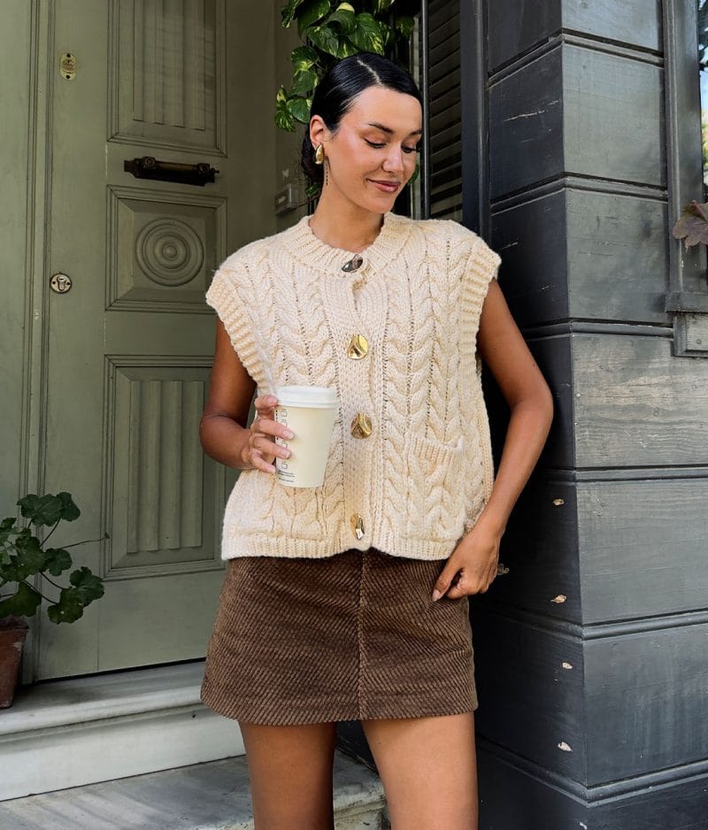 buttoned knit vest styled with mini skirt