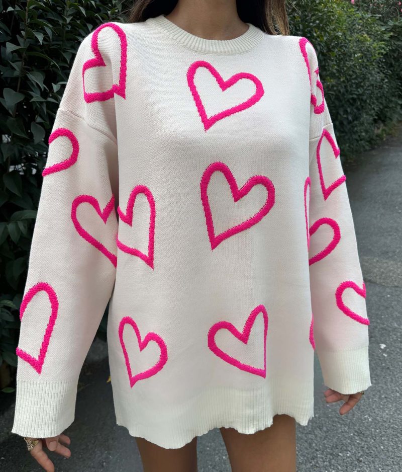 model styling heart pattern knit sweater outdoors