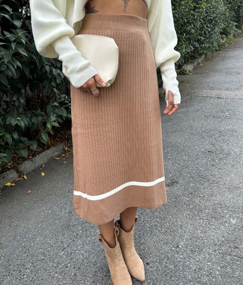 close-up of rib knit skirt with white stripe hem detail