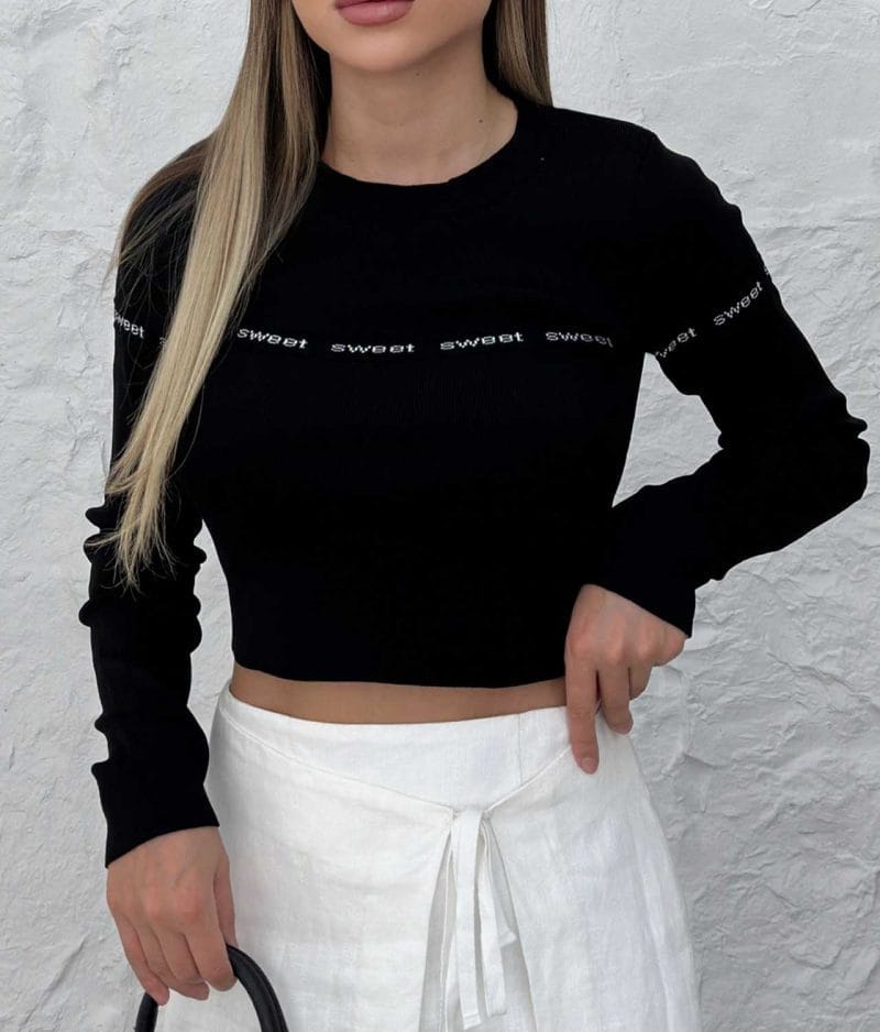 Close-up of sweet lettering cropped sweater