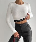Ribbed long sleeve crop top with PRETTY logo waistband in white – front view