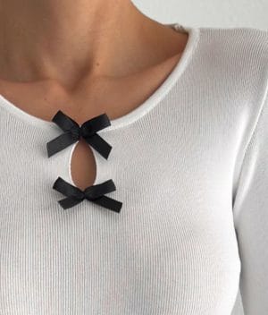 Long sleeve knit top with stylish bow embellishments and keyhole cutout