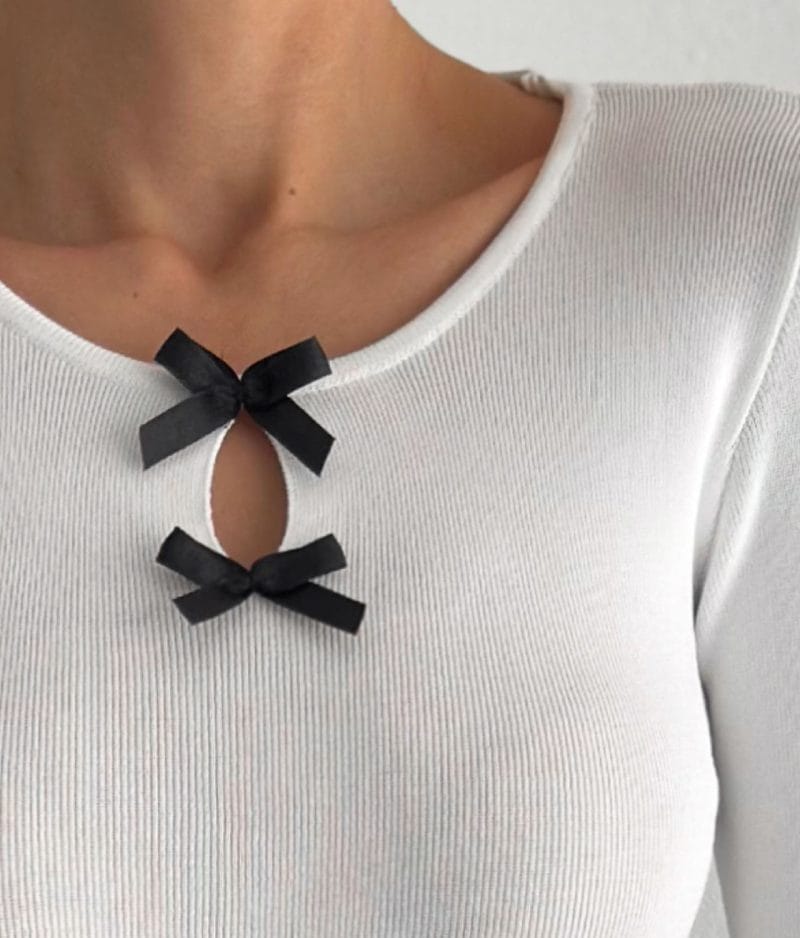 Long sleeve knit top with stylish bow embellishments and keyhole cutout