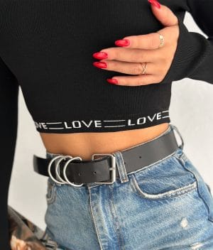 close‑up of LOVE logo hem on ribbed black crop sweater