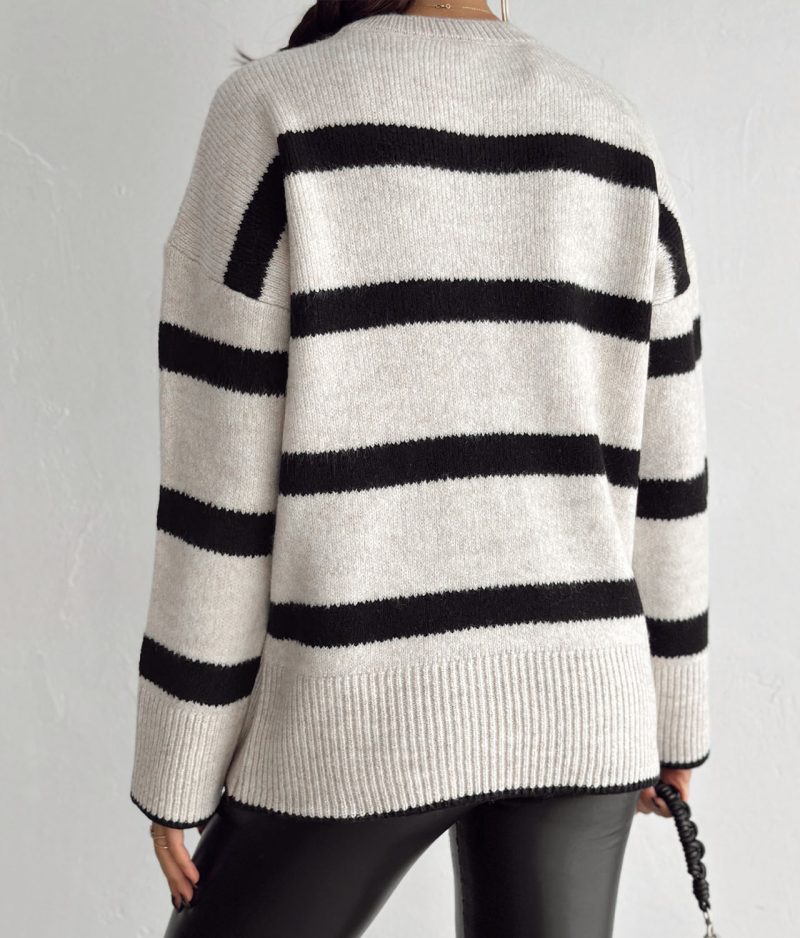 model styling striped knit sweater with handbag