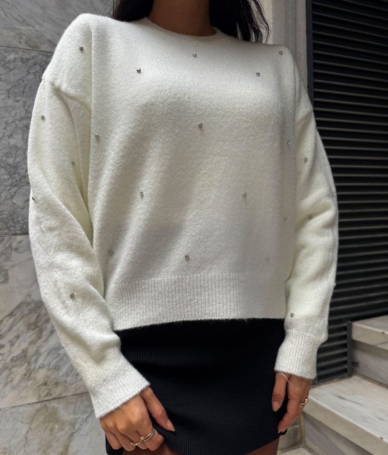 Close-up of pearl detailing on women’s knit pullover