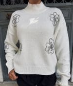close-up of floral embroidered sweater details