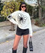 Oversized white knit sweater with black floral embroidery on front and sleeves