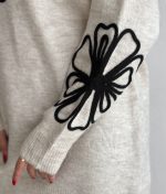 close-up floral embroidery on knit sleeve