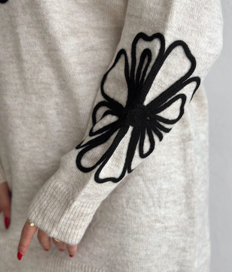 close-up floral embroidery on knit sleeve