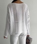 model wearing open knit mixed pattern sweater with casual pants