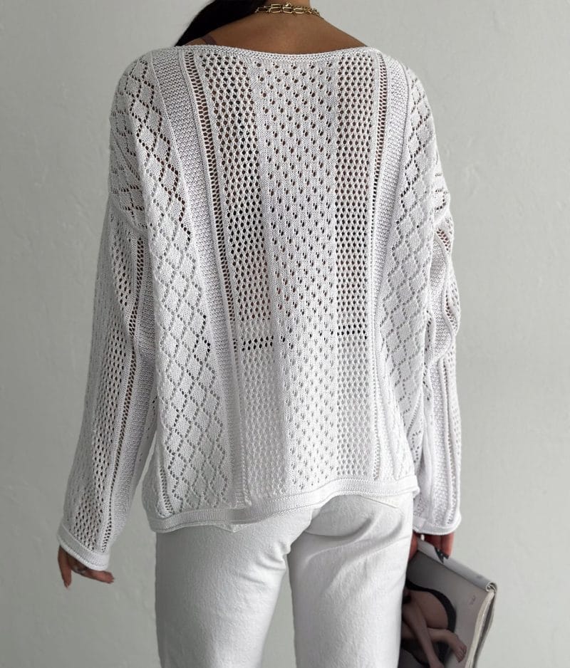 model wearing open knit mixed pattern sweater with casual pants
