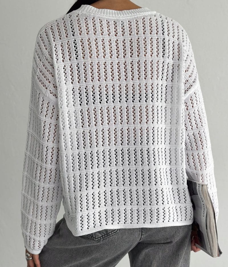 model wearing open knit horizontal stripe sweater
