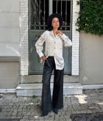 off-white knit vest styled over satin shirt