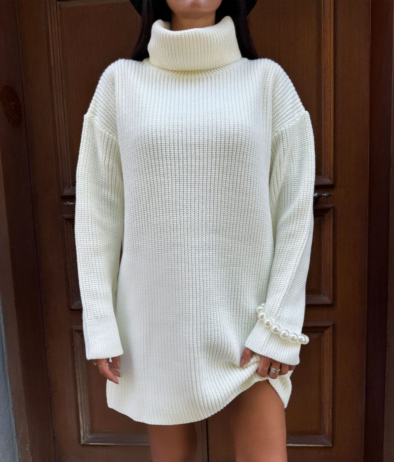 close-up of turtleneck knit dress texture and pearl accents