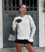 front view of embellished ruffle hem knit sweater