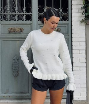 women’s knit sweater with crystal embellishments and ruffle details