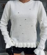 close-up of ruffle hem knit pullover with embellishments