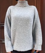model wearing ribbed knit turtleneck sweater