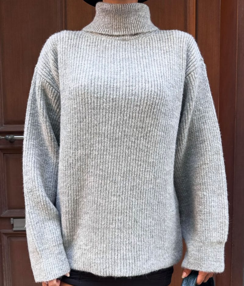 model wearing ribbed knit turtleneck sweater