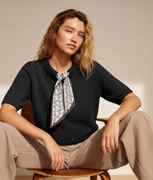 black knit top with scarf accessory