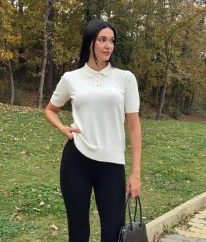 Women’s short sleeve polo knit top featuring a minimal button placket