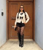 Classic knit cardigan with decorative bow detail and cozy texture