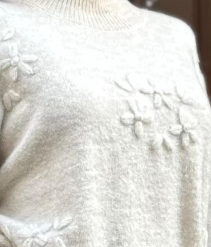 Raised floral knit sweater detail close-up