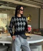 Women’s argyle pattern knit sweater featuring a timeless silhouette
