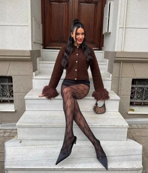 Women’s knit cardigan featuring feather cuff sleeves and classic fit