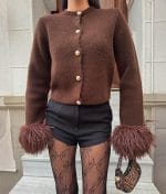 Modern feather cuff knit cardigan styled with feminine silhouette
