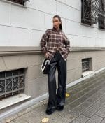 Classic plaid shirt styled with black leather pants