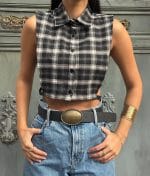 Sleeveless cropped plaid shirt styled with high-waisted denim