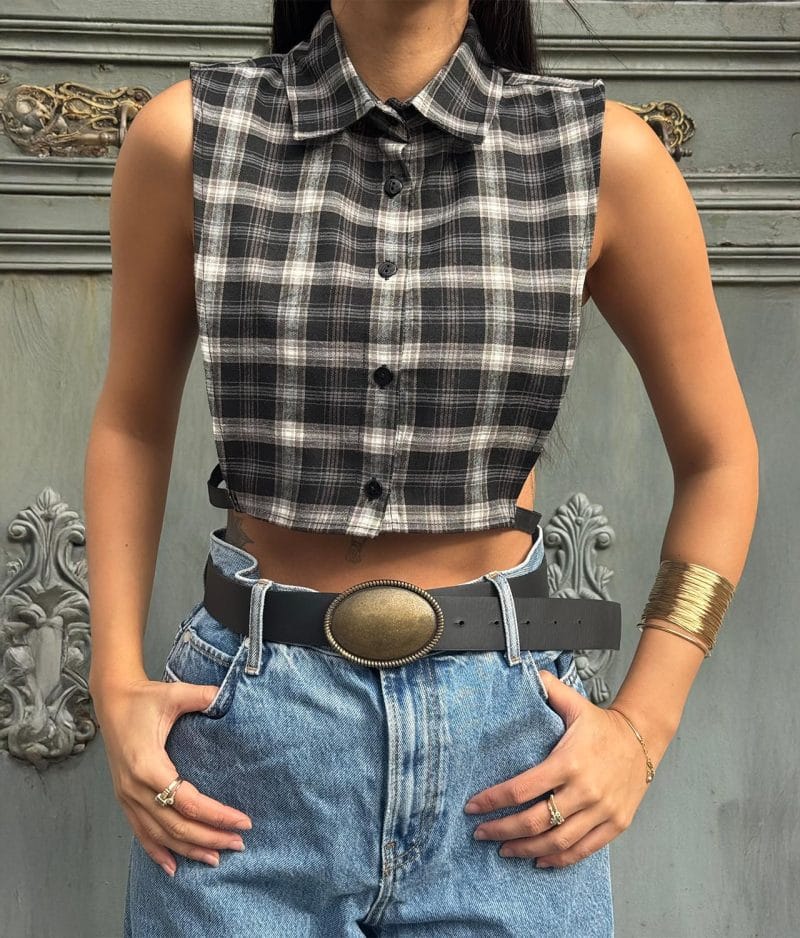 Sleeveless cropped plaid shirt styled with high-waisted denim
