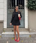 Long sleeve embellished knit sweater styled with skirt