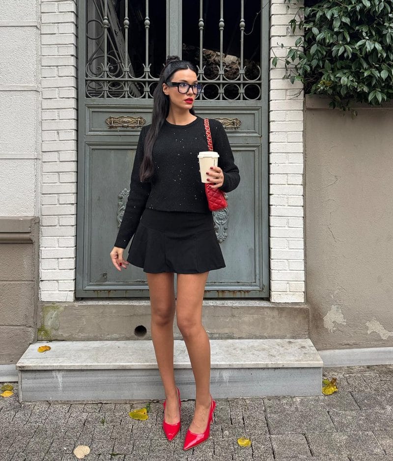 Long sleeve embellished knit sweater styled with skirt