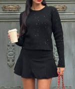 Close-up of embellished details on knit sweater