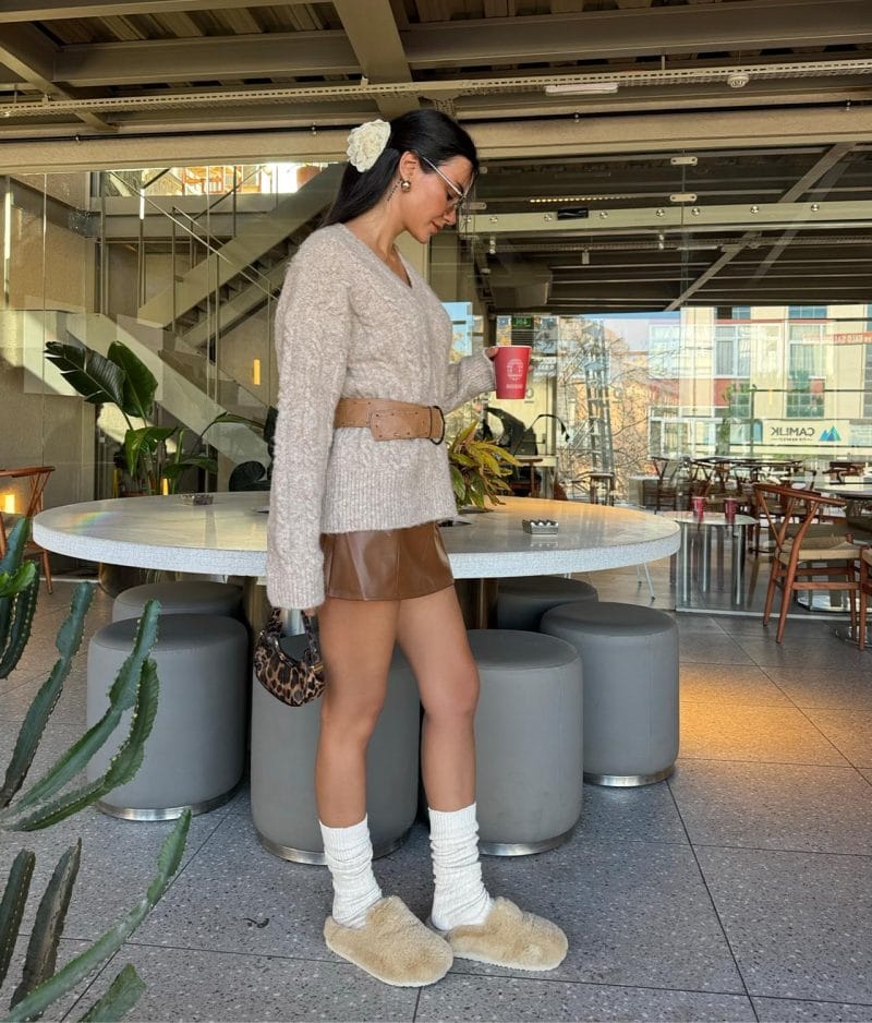 Classic cable knit V neck sweater styled with belt