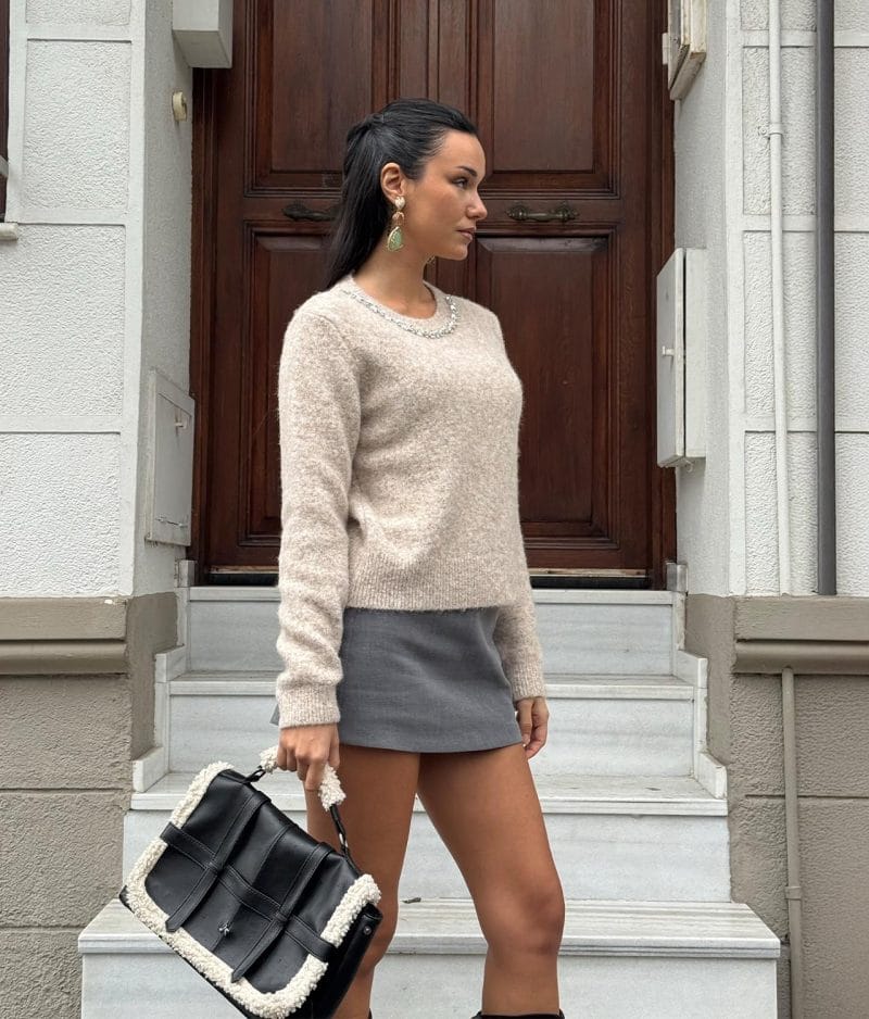 Crystal trim knit sweater styled with mini skirt for boutique fashion