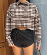 Cropped plaid shirt hem detail close-up