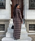 Plaid shirt dress styled with tall boots